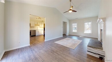 Unfurnished living room with a ceiling fan, dark w
