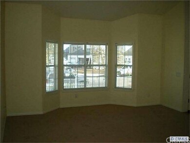 Large formal living room with a big bay window
