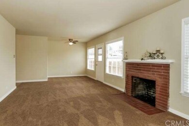 Living and dining combo with wood burning fireplac