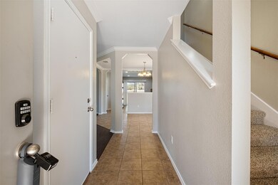 Hallway featuring stairway, baseboards, ornamenta