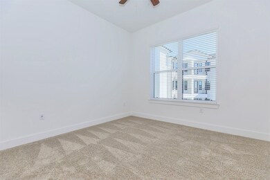 Primary bedroom with large window and ensuite bath