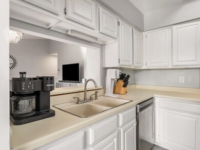 Kitchen featuring white cabinetry, sink, a texture