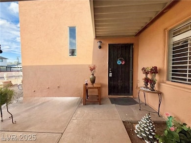 Doorway to property featuring stucco siding and covered porch
