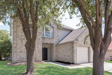 View of front of house featuring a garage and a fr