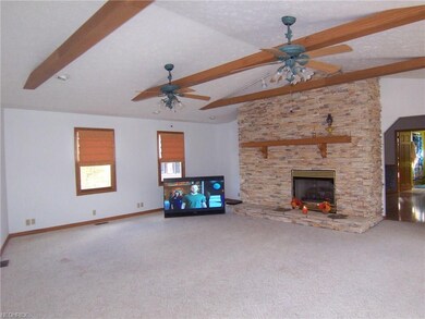 Living room also has double ceiling fans and leads