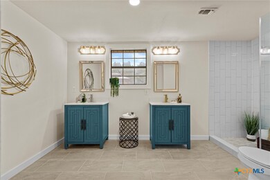 The expansive primary bath features a walk-in show