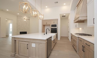 Kitchen with a chandelier, ceiling fan, premium r