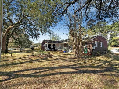 Exterior space with a porch, brick siding, and a f