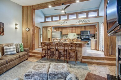 Living room featuring ceiling fan, sink, and a tow