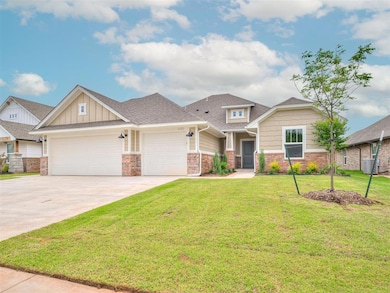 Craftsman house featuring a garage and a front law