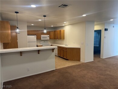 Kitchen with white appliances, tile countertops, b
