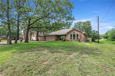 View of front of home featuring a front lawn and b