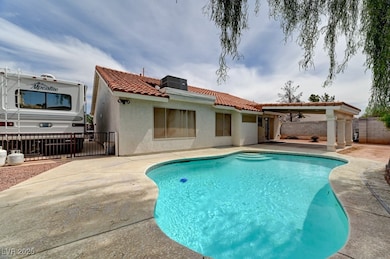 Back of house featuring a tiled roof, a patio area