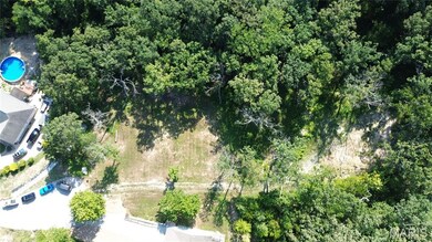 Aerial overview of property's location with a heavily wooded area