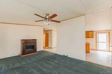 Unfurnished living room featuring light carpet, a