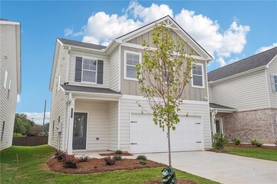 View of front of house with a garage, fence, drive
