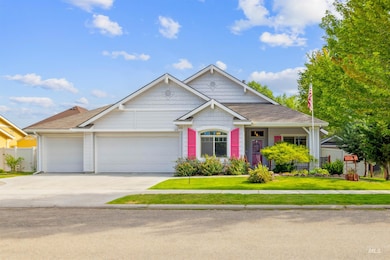 Craftsman-style house featuring driveway, an attached garage, and roof with shingles