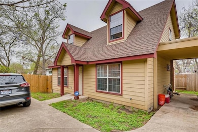 View of front of home with fence and roof with sh