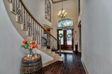 THE ENTRYWAY SHOWCASES THE BEAUTIFUL DOORS AND A C