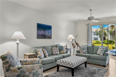 Living room featuring ceiling fan and light hardwo