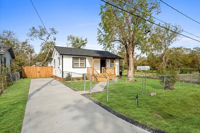 View of the driveway, walking path and front yard