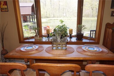 Eating area in kitchen has bay window with view of