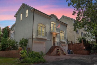 View of front of home with a balcony and a garage