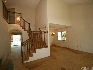 Open floor plan with high vaulted ceilings and a f