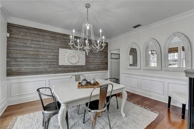 Dining space featuring dark wood-style floors, vis