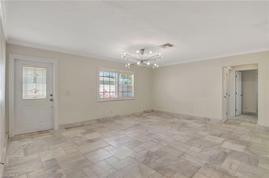 Entryway into Great room with ornamental chandelie