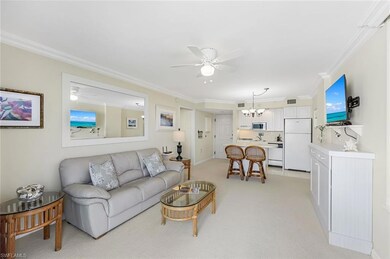 Living room with ornamental molding, ceiling fan w