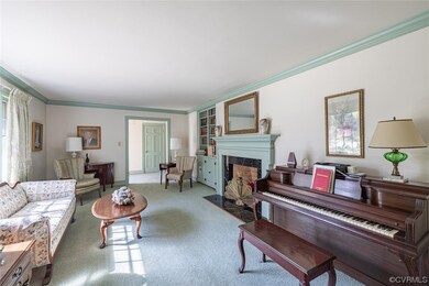 Carpeted living room with ornamental molding