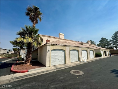 View of front facade with community garages, stucc