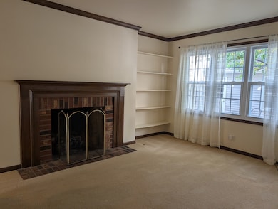 Brick fireplace with gas logs, carpeted, triple wi