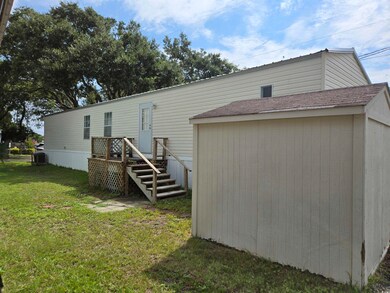 Back of house with a lawn
