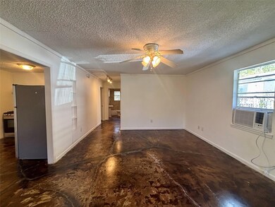 Unfurnished room featuring ceiling fan, a textured ceiling, concrete flooring, and cooling unit