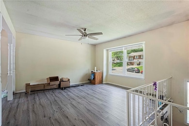 Sitting room featuring a textured ceiling, ceiling fan, and hardwood / wood-style floors