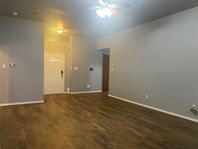 Spare room with ceiling fan and dark wood-type flooring