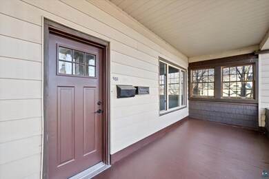 View of exterior entry with a porch