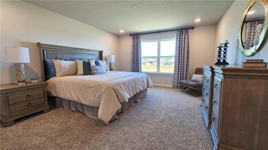 Bedroom featuring light carpet, a textured ceiling
