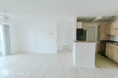 Kitchen with dark countertops, a ceiling fan, frid
