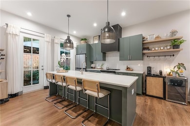 Kitchen featuring light wood finished floors, a si