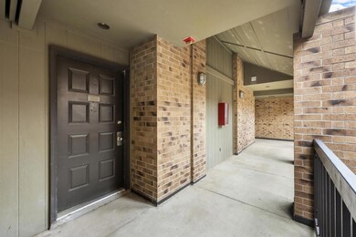 Doorway to property featuring brick siding
