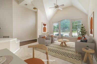 staged Living room featuring ceiling fan and high 