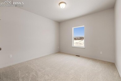 Spare room featuring light colored carpet and baseboards