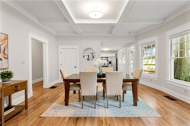 Spacious dining room with coffered ceilings and large coat closet