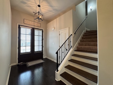 Foyer entrance featuring dark wood-style flooring,