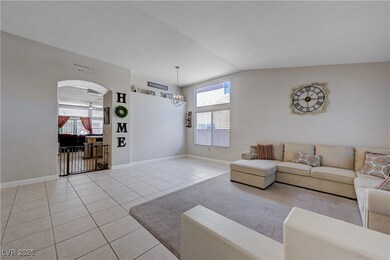 Living area with light tile patterned floors, a he