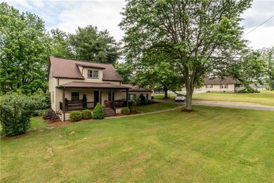 Front of house! Lovely front porch with fresh land