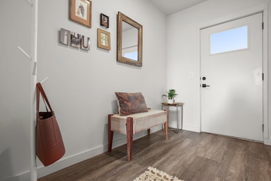Foyer featuring wood finished floors and baseboar
